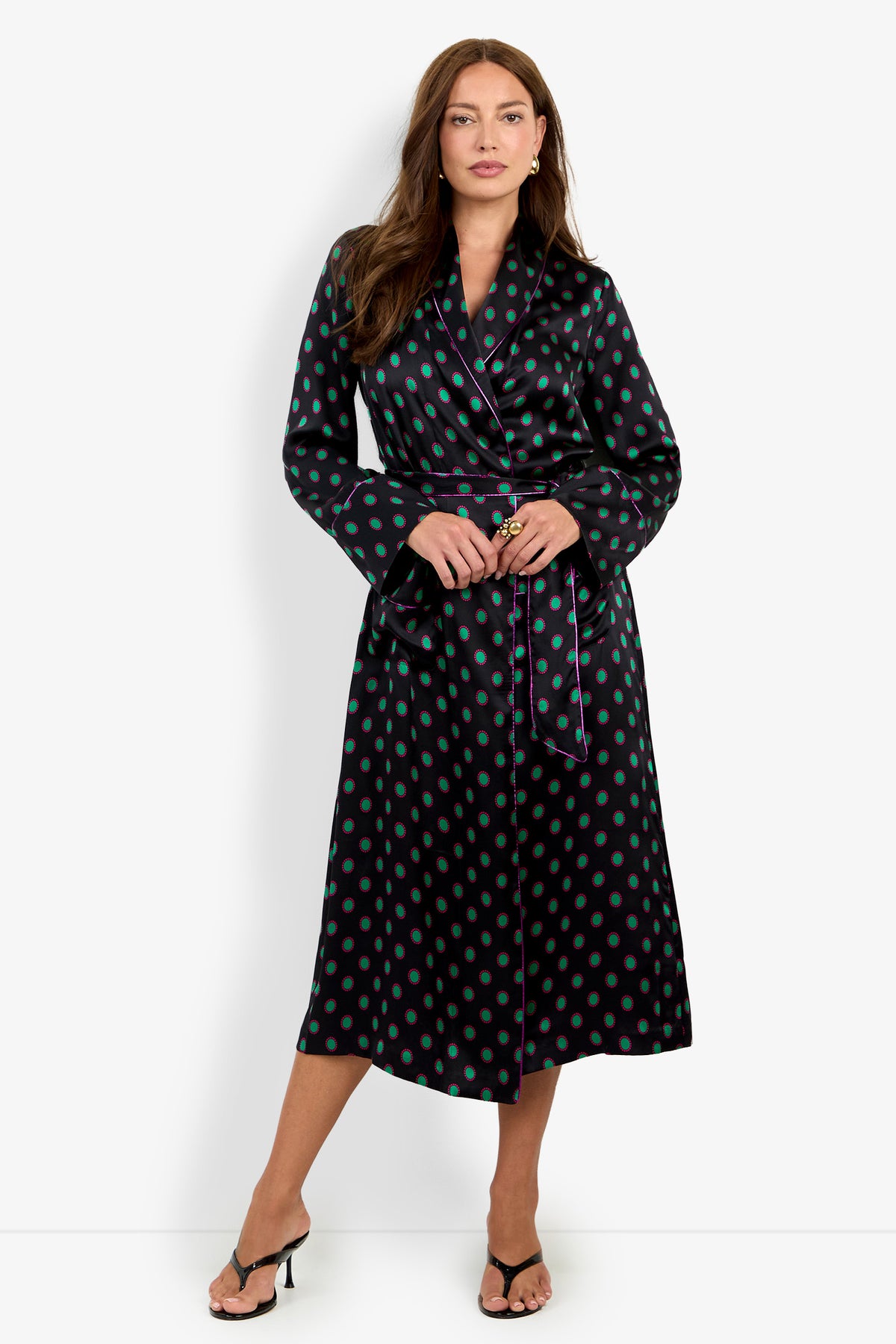 The ADALYNN ROBE is a black, calf-length silk robe with a green polka-dot pattern and purple piping, tied at the waist with a matching sash.