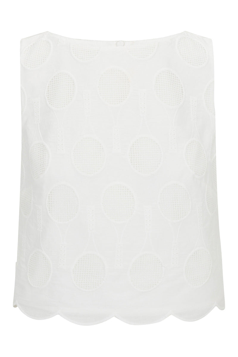The Split Sleeveless Crop Top - Tennis Eyelet is a white, sleeveless top with embroidered tennis rackets and balls, plus a scalloped hem.