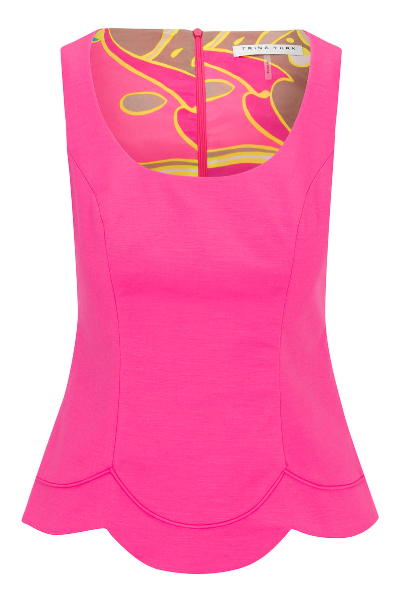 The Forehand Sleeveless Scallop-Hem Top - Solid Suiting is a fitted hot pink top with a scoop neckline, scalloped hem, exposed back zipper, and “Trina Turk” label. The inside lining features yellow and brown swirl patterns.