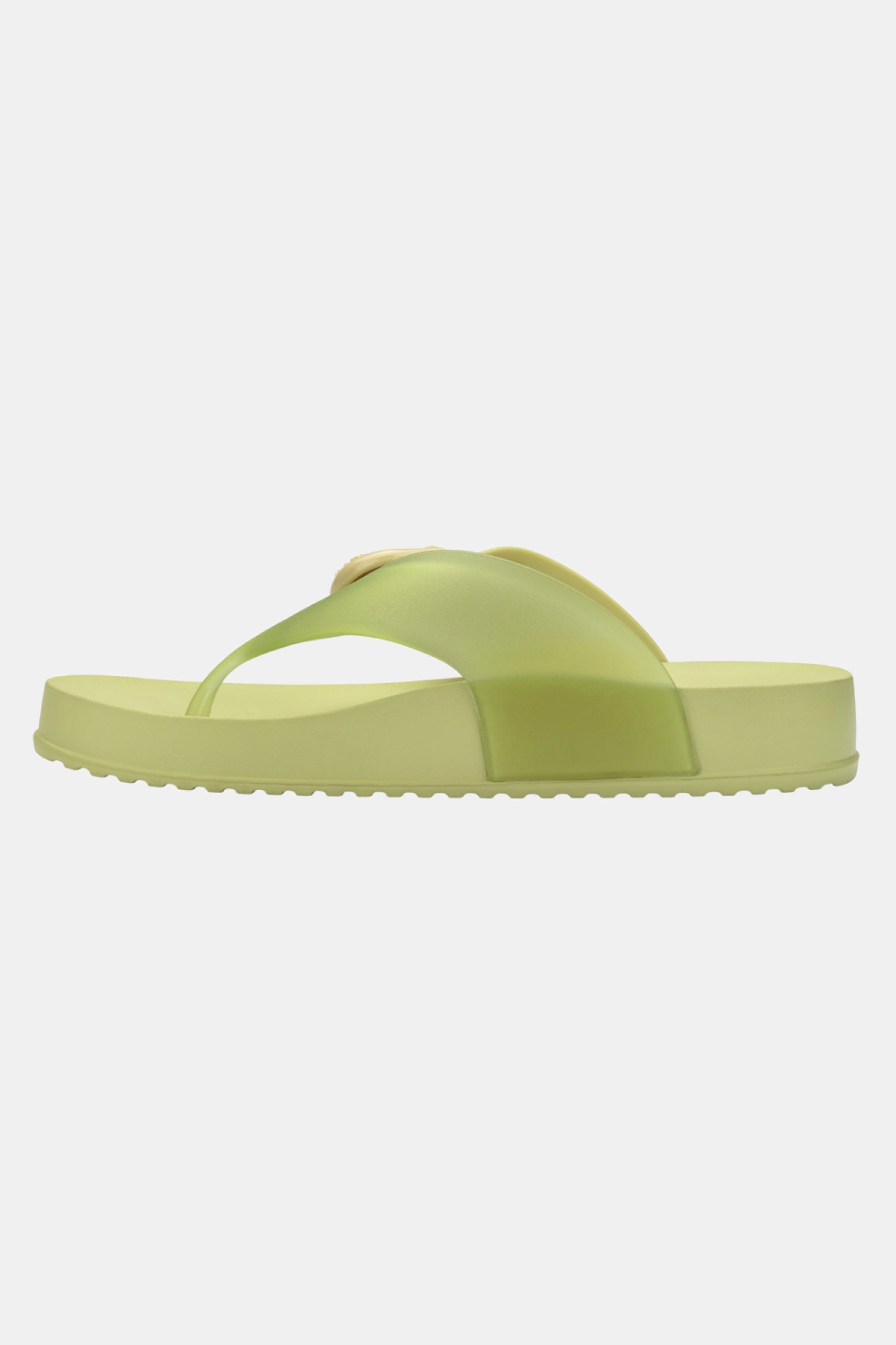 The Melissa Cozy Thong is a single light green flip-flop sandal with a thick sole and modern, minimalist design, shown in side profile on a plain white background.