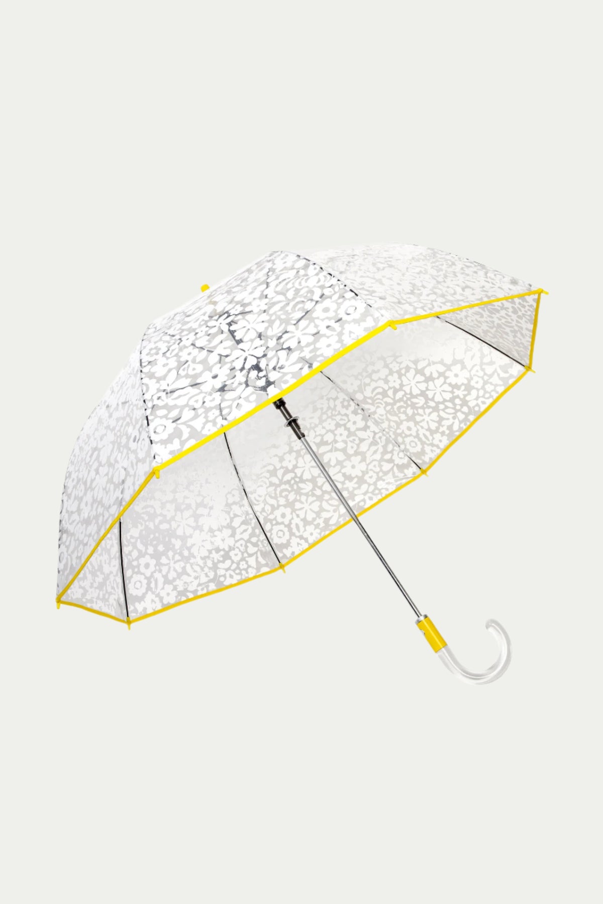 The TT X SR Clear Bubble Umbrella - Poolside features a transparent canopy with a white floral pattern, yellow-trimmed edges, a metal shaft, and a clear curved handle, shown against a light gray background.