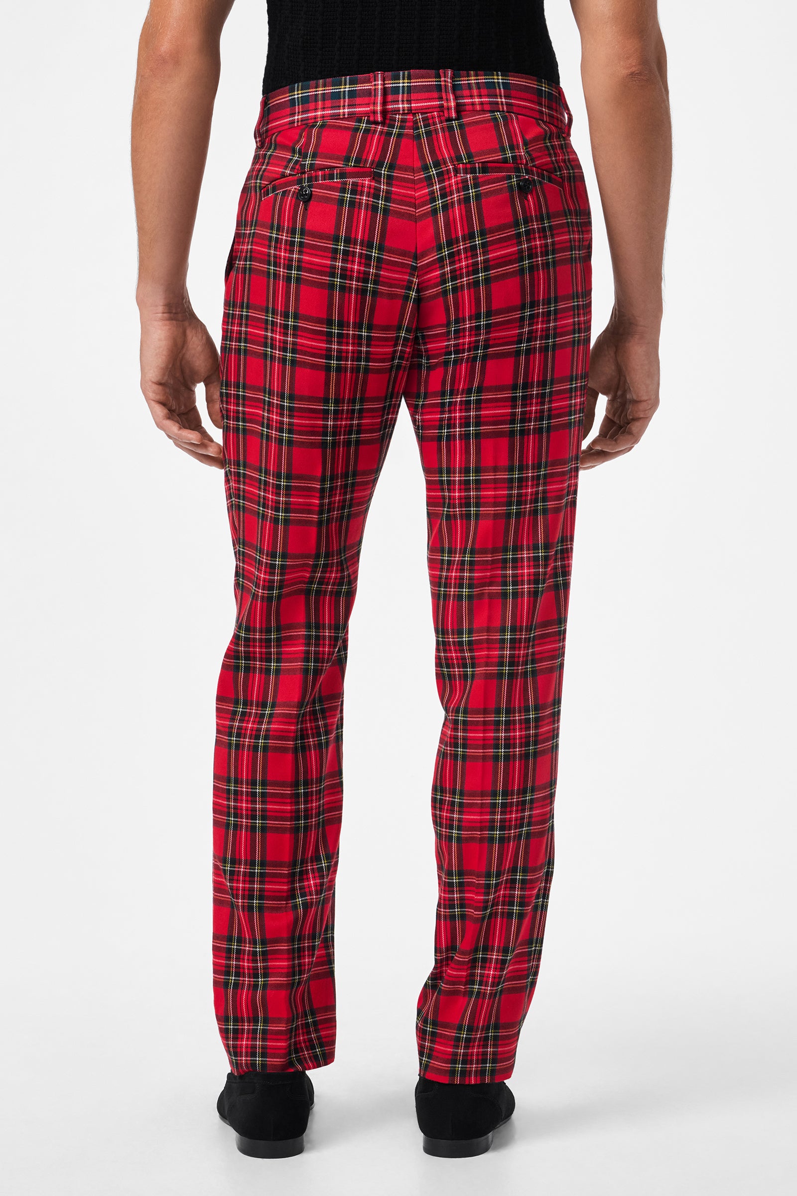 Model faces away, wearing the Clyde Slim Trouser - Can-Can Check, featuring red and black plaid with back pockets and a fitted design. Styled with a black top against a plain white background.
