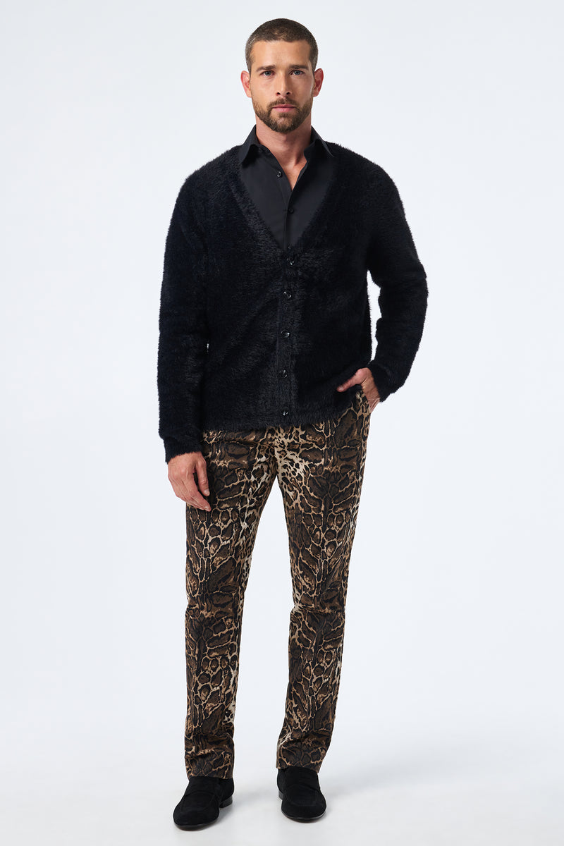 A man faces forward against a plain white background, wearing the Scott Fuzzy Cardigan in black, a black dress shirt, brown leopard-print pants, and black shoes.