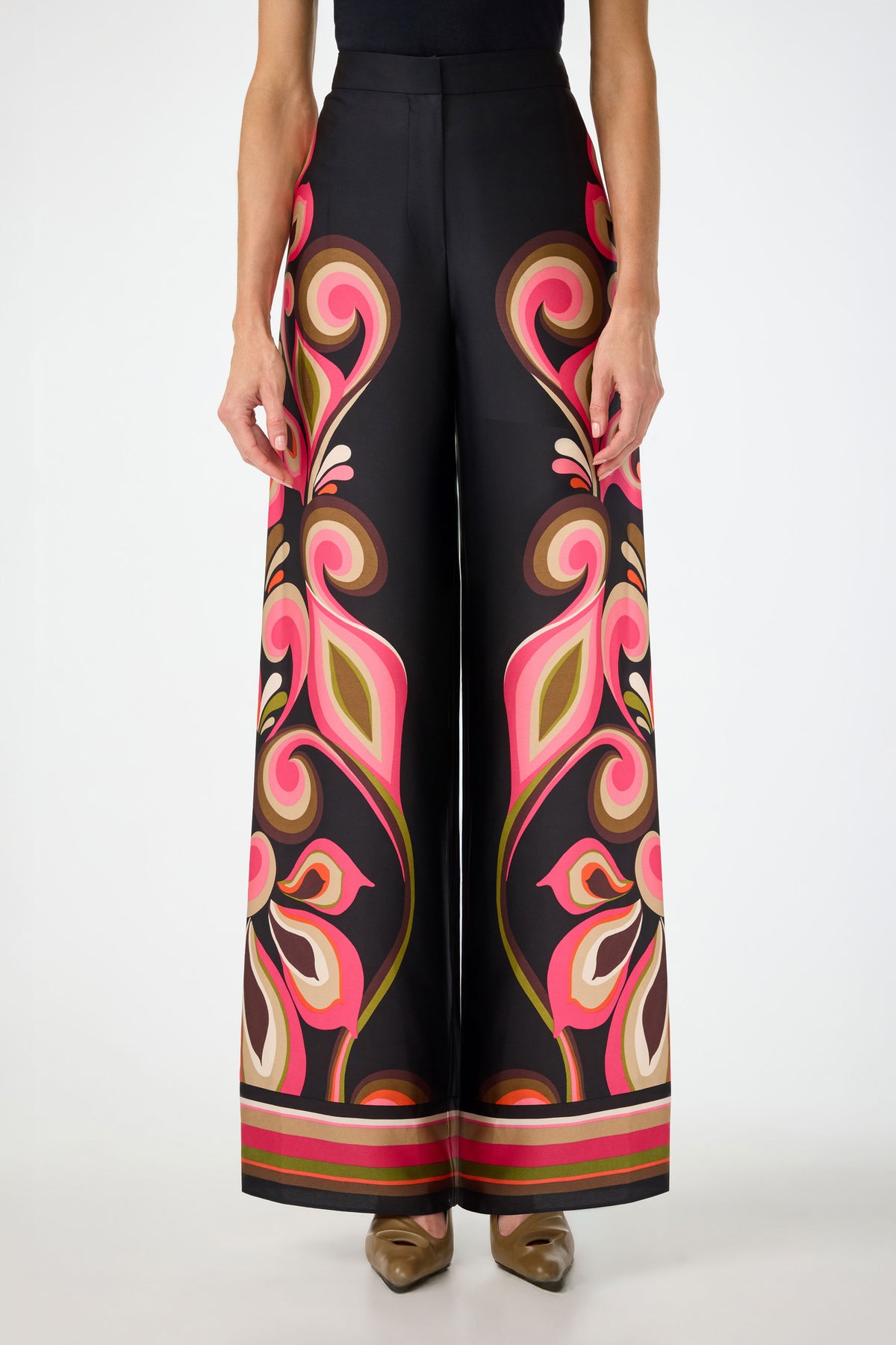 Someone wears the Verity Border Pants in Sanctuary—a high-waisted, wide-leg style featuring a bold paisley pattern in pink, orange, green, and cream—standing against a plain white background.