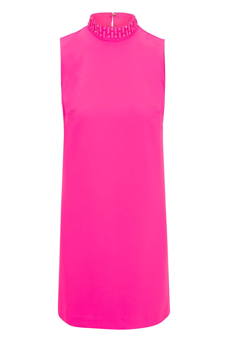The Sharapova Sleeveless Mockneck Dress features a high neckline with rectangular cutout details, a small back zipper, and a smooth, slightly shiny bright pink fabric.