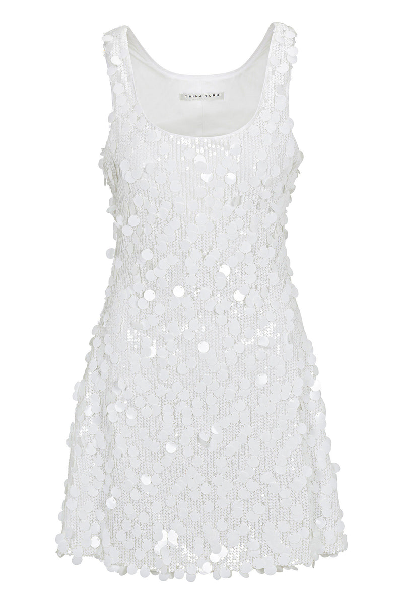 The Score Sleeveless Sequin Skater Dress is a white mini dress with large shiny floral sequins, a scoop neckline, and a slightly flared hem.