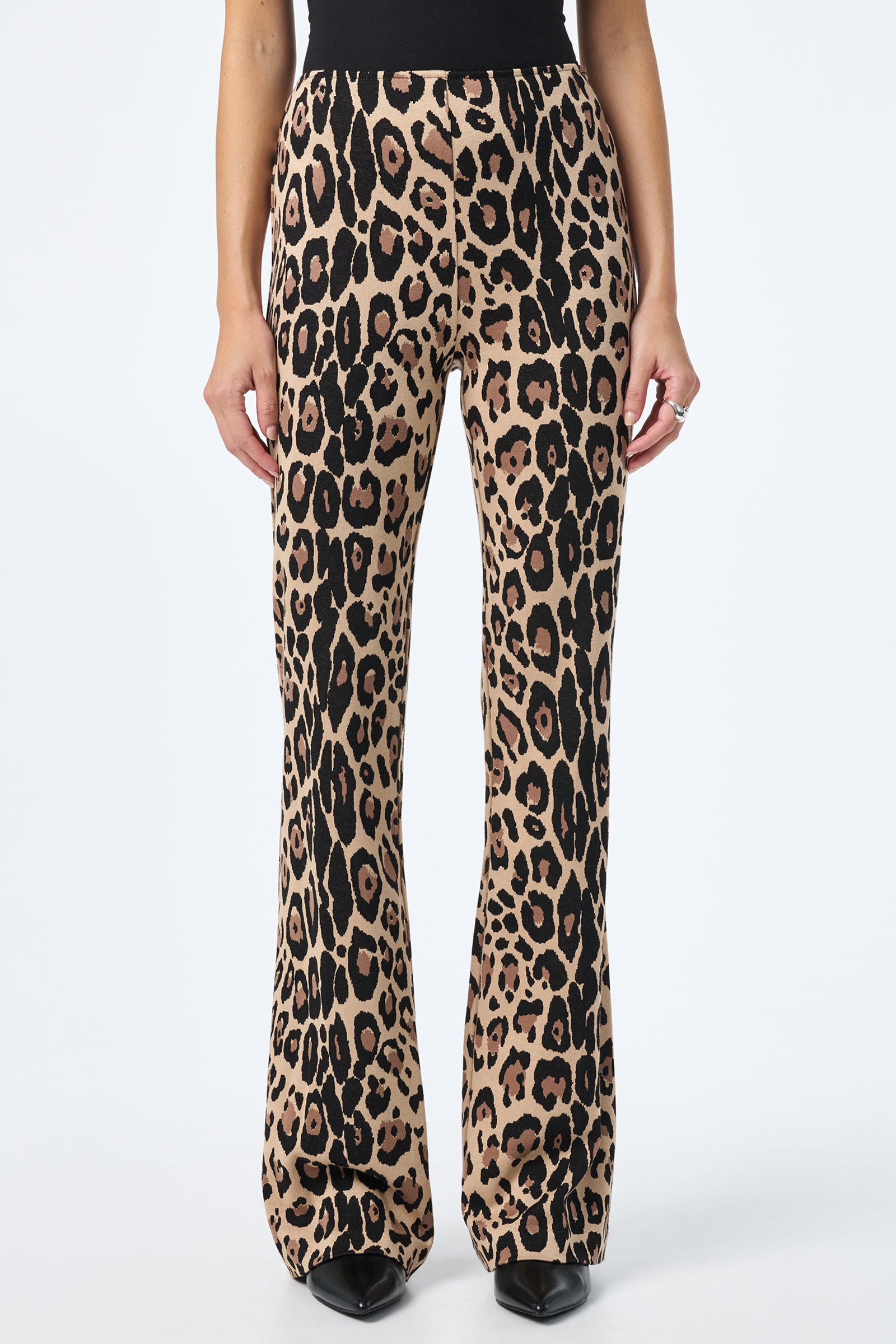 A person wearing Jacoba Slim-Fit Bootcut Pants stands against a white background, styled with black pointed-toe shoes.