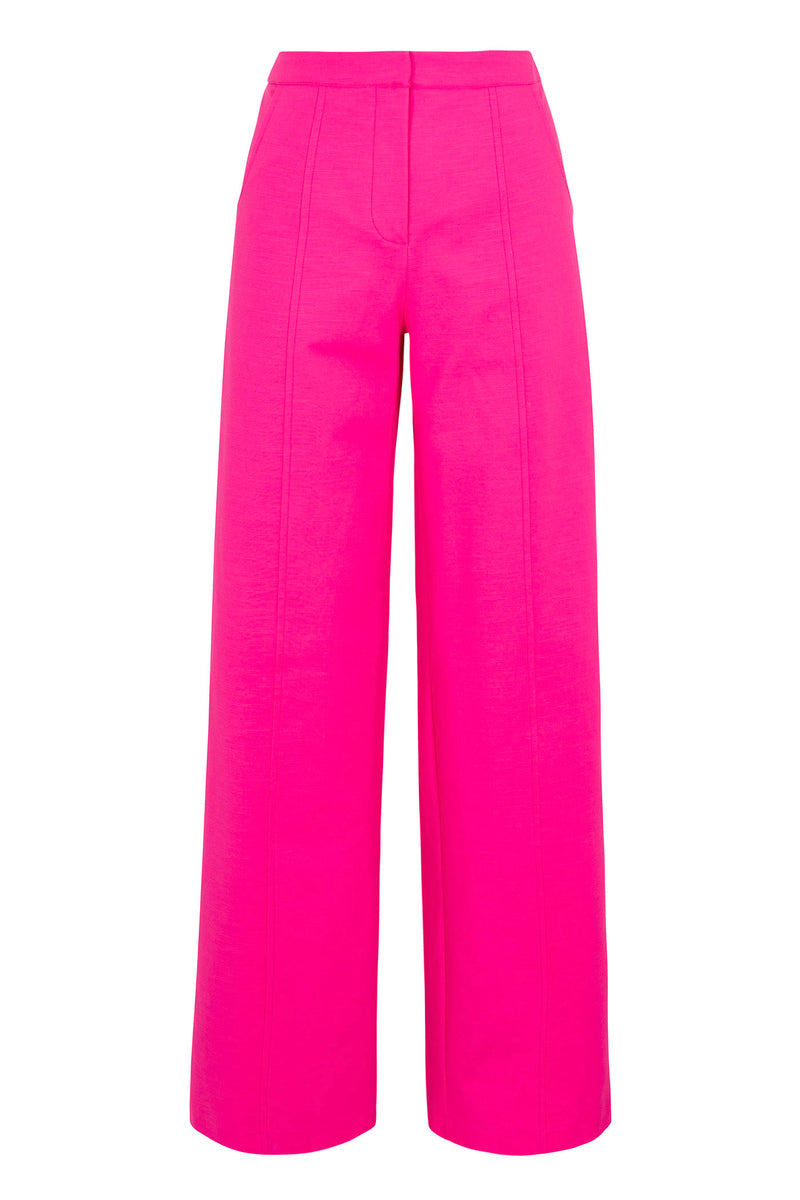 The Half Court Wide-Leg Pant in solid suiting features a bright pink, high-waisted silhouette with front seam details, displayed against a plain white background.