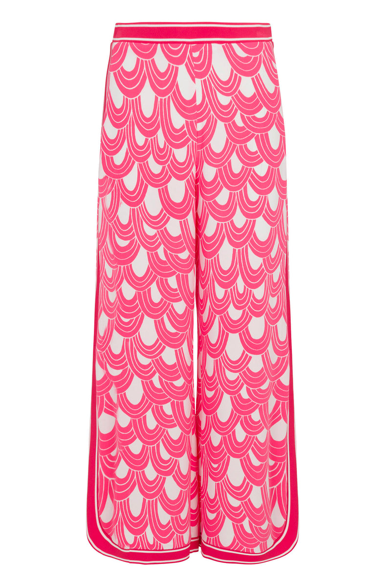 The Overhead Wide-Leg Pant - Ace Arches features a high waist, bold pink and white scalloped pattern, and pink trim along the sides and waistband.