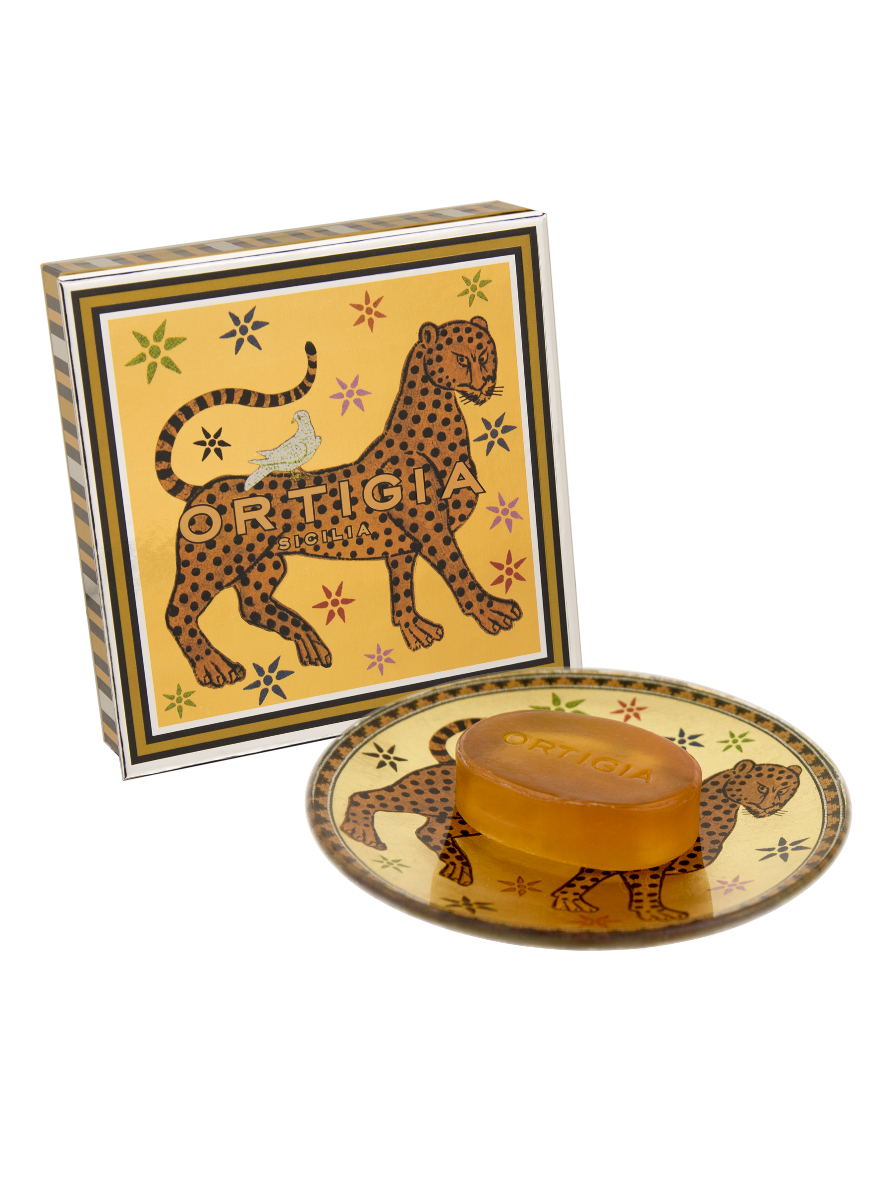 The Ortigia Ambra Nera Soap/Plate set features an amber soap on a patterned dish with a matching box, all decorated with leopards, stars, and bold gold and black accents.