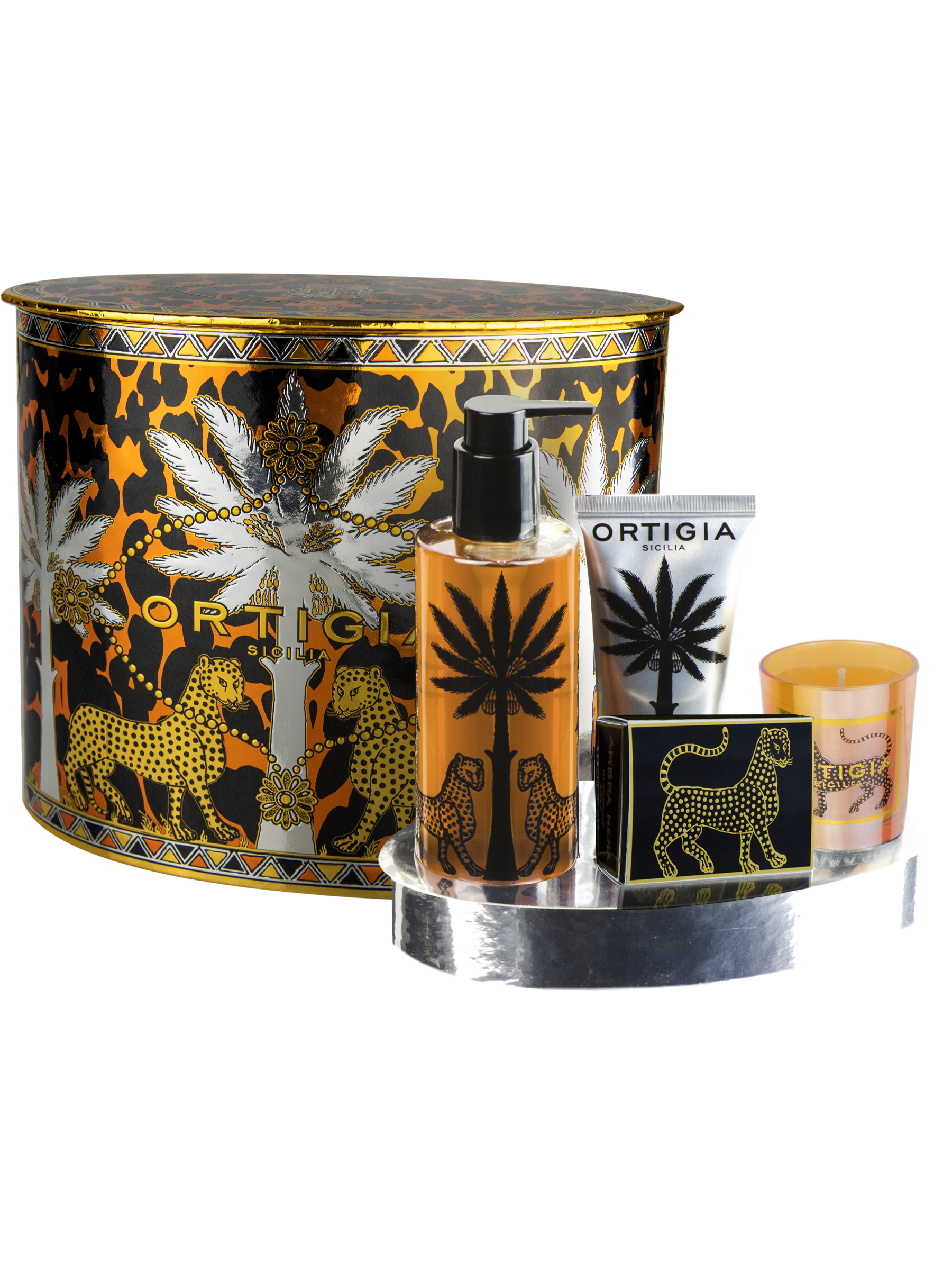 The Ortigia Ambra Nera Soap 4P Set in amber includes liquid soap, hand cream, a small bar soap, and a votive candle in a decorative tin with leopard and palm tree motifs, all elegantly arranged on a silver tray.