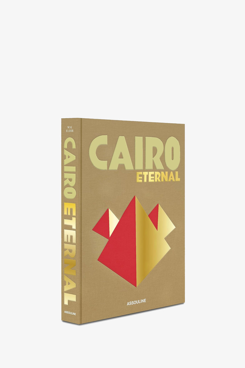 A tan Assouline Cairo Eternal book shown at an angle, with the red and gold pyramid design on the cover and the title in gold along the spine.
