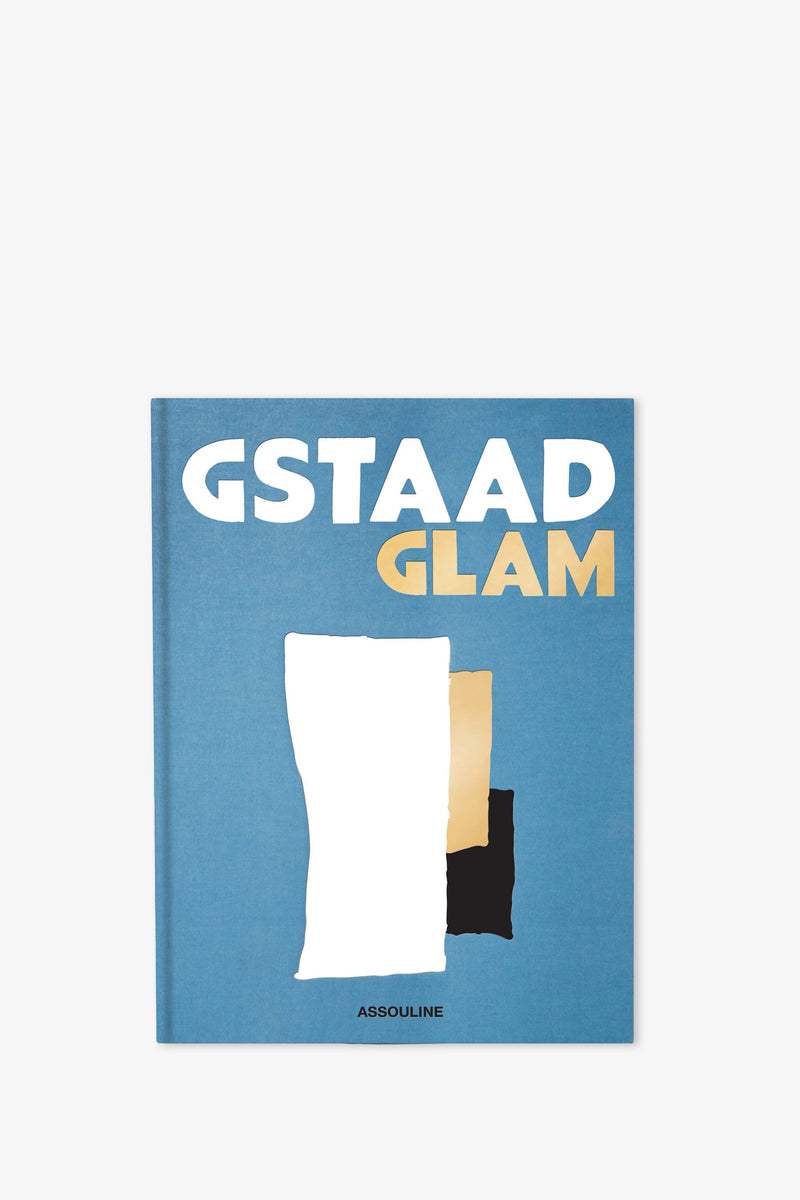 The Assouline Gstaad Glam Book features a blue cover with bold white and gold letters, abstract shapes in white, gold, and black, and the Assouline logo at the bottom.