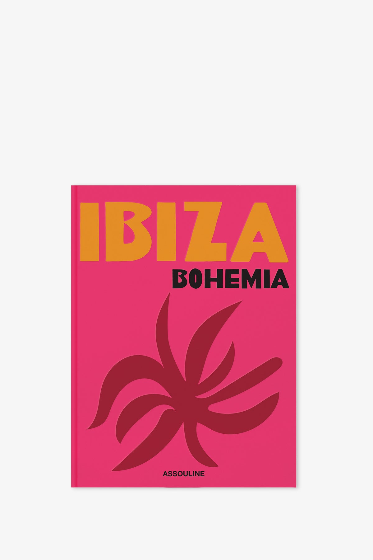 A vibrant pink cover of the Assouline Ibiza Bohemia Book displays the title "IBIZA BOHEMIA" in striking yellow and black lettering, with an abstract dark pink graphic and the publisher's name, ASSOULINE, featured at the bottom.
