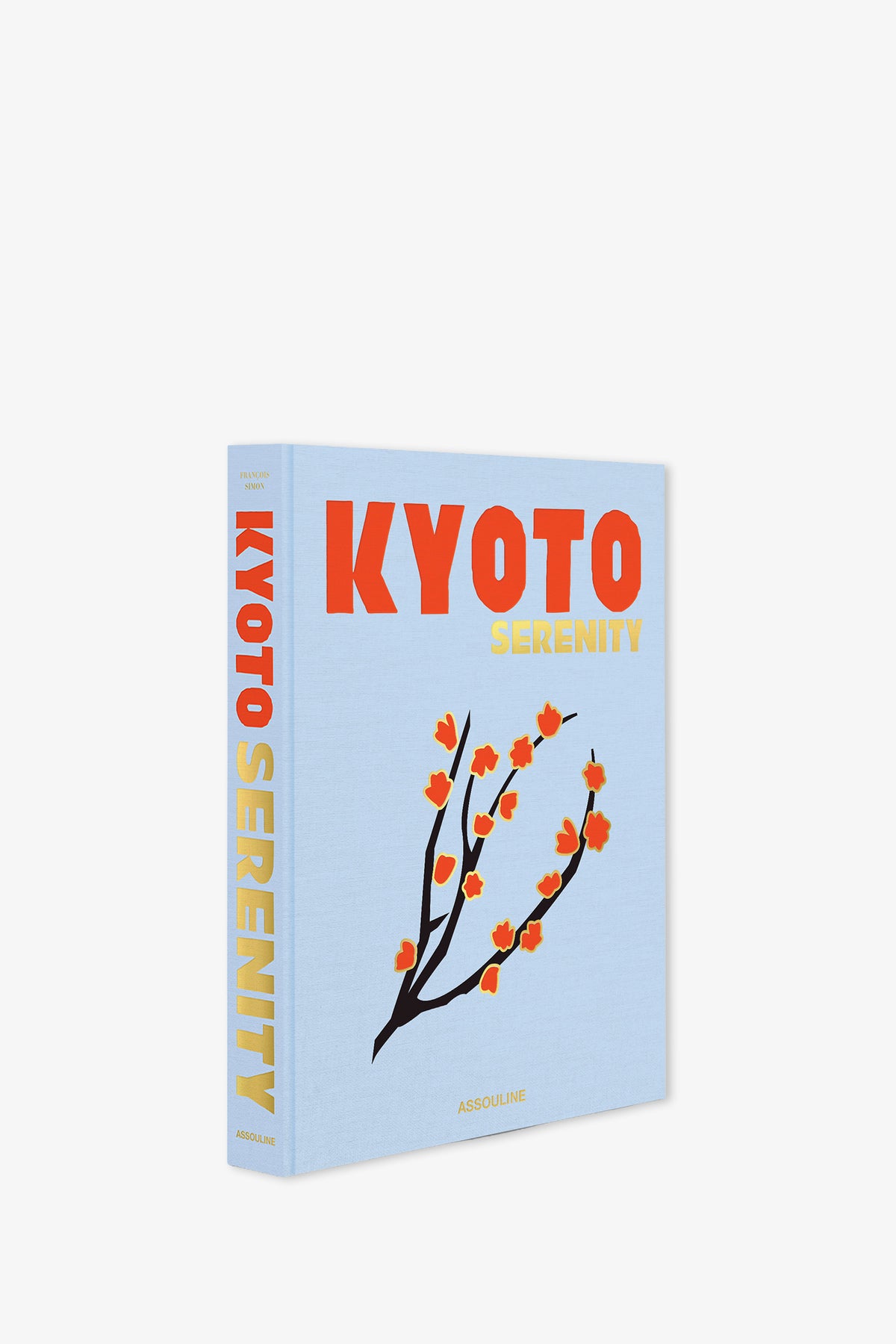 The Assouline Kyoto Serenity Book features a light blue cover with the title “KYOTO SERENITY” in bold red and yellow lettering, accented by an illustration of a branch with orange flowers. The spine also showcases the title in yellow text.