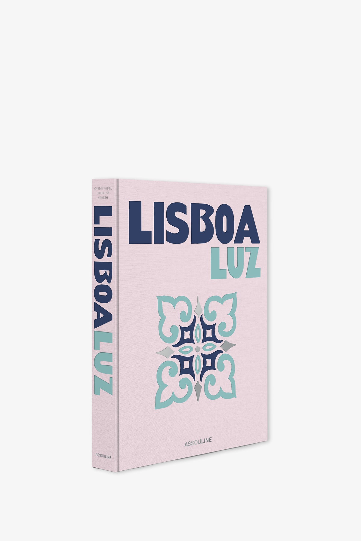 The Assouline Lisboa Luz Book is a pink hardcover featuring bold blue and teal text and a decorative floral tile pattern on the front, with the title displayed vertically on the spine.