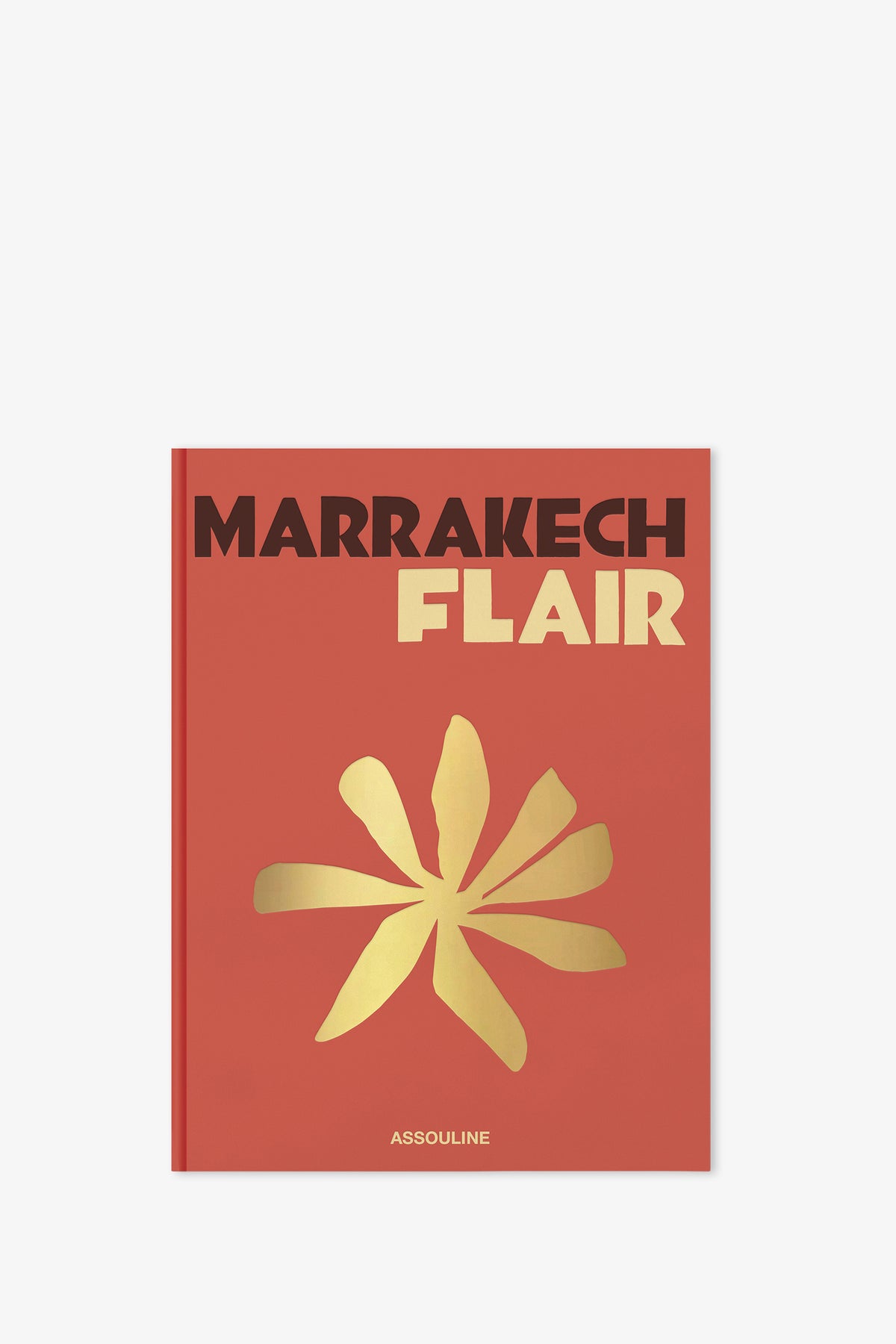 A red Assouline Marrakech Flair Book featuring a gold abstract flower design and the publisher's name, Assouline, at the bottom of the cover.