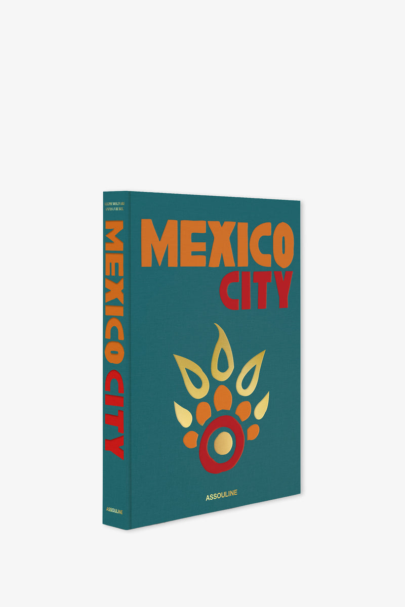 The Assouline Mexico City Book features bold orange and red text with a decorative gold and red graphic on a teal cover, and the publisher's name, Assouline, printed at the bottom.
