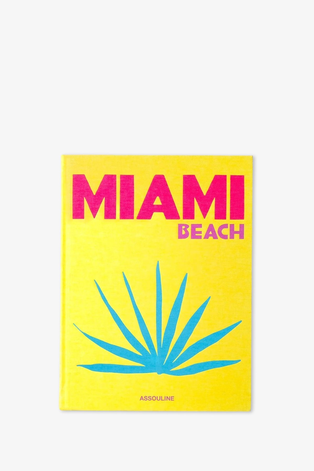 A bright yellow cover adorns the Assouline Miami Beach Book, featuring “MIAMI BEACH” in bold pink letters and a blue palm leaf graphic below, with the publisher Assouline’s name at the bottom.
