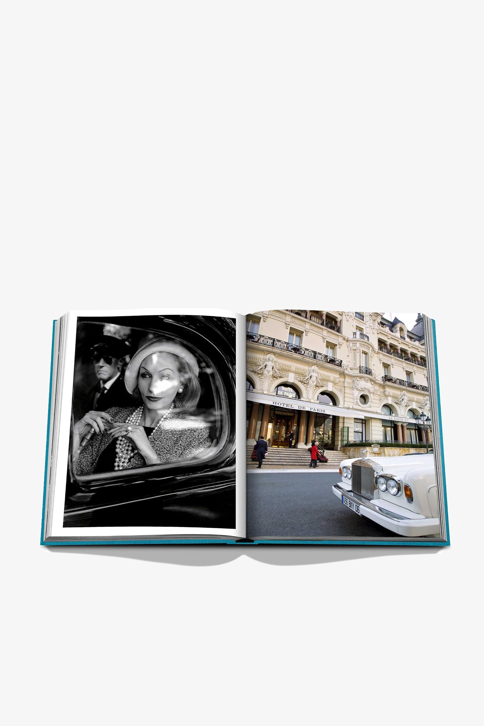 An open Assouline Monte Carlo Book displays a black-and-white photo of a woman in a car on the left page and a color photo of a hotel with a white car parked outside on the right page.