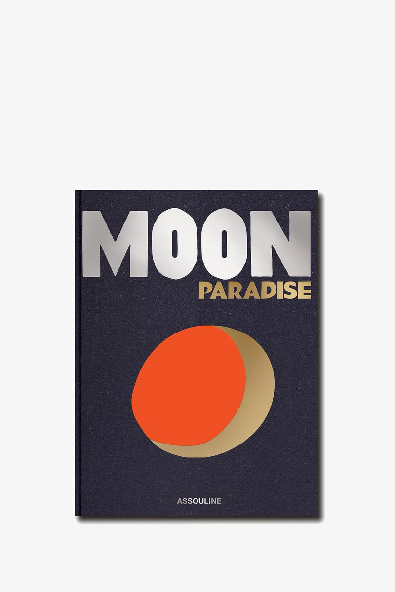 The Assouline Moon Paradise Book features a dark cover with bold silver and gold lettering and an abstract orange-and-gold moon shape, with the publisher’s name, Assouline, displayed at the bottom.