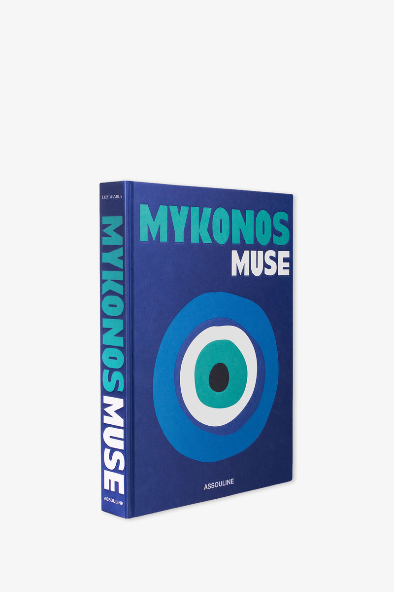 A blue hardcover Assouline Mykonos Muse Book featuring bold white and turquoise lettering and an abstract blue eye design on the cover.