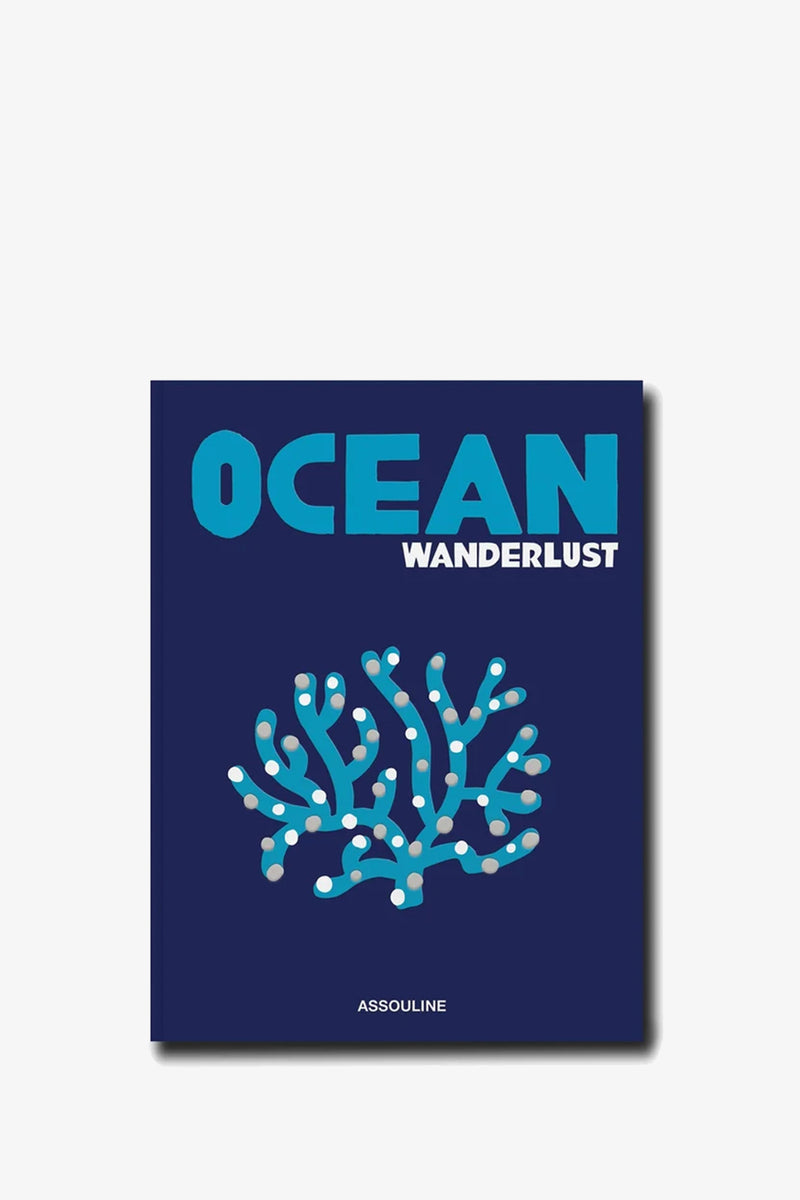 A blue book titled Assouline Ocean Wanderlust, featuring an illustration of turquoise coral and white dots on the cover, with the publisher’s name, Assouline, printed at the bottom.