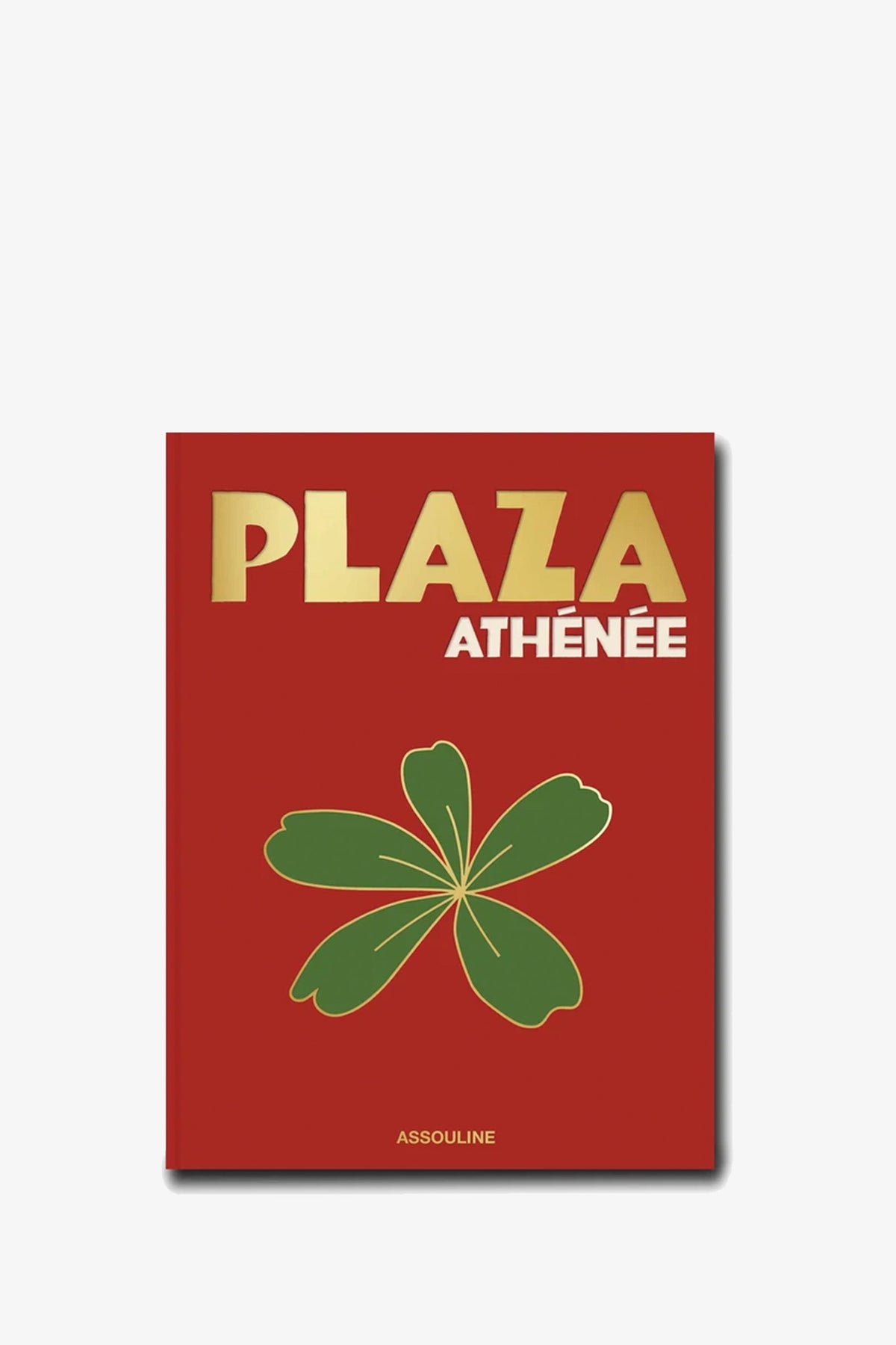 The Assouline Plaza Athénée book features a red cover with the title “PLAZA ATHÉNÉE” in gold above a green and gold flower illustration, with the publisher ASSOULINE at the bottom.