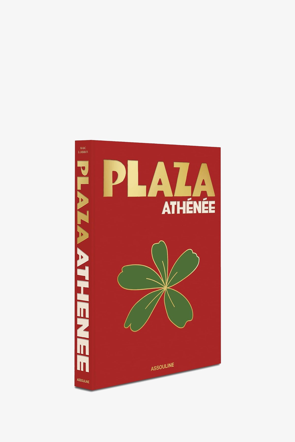 A red Assouline Plaza Athénée book shown at an angle, with the green flower illustration on the cover and the title in gold along the spine.