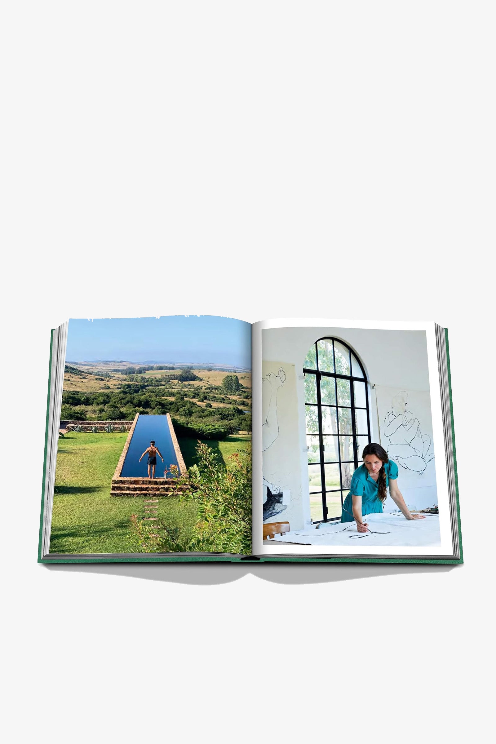 The Assouline Punta Del Este Book is open to a spread featuring a tent set in a grassy landscape on the left page and a woman sketching at a table near a large arched window on the right page.