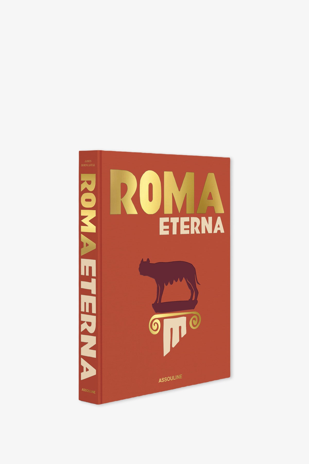 The Assouline Roma Eterna Book features a striking red cover with gold and white lettering, showcasing a stylized wolf standing on a column, and the ASSOULINE publisher's name at the bottom.