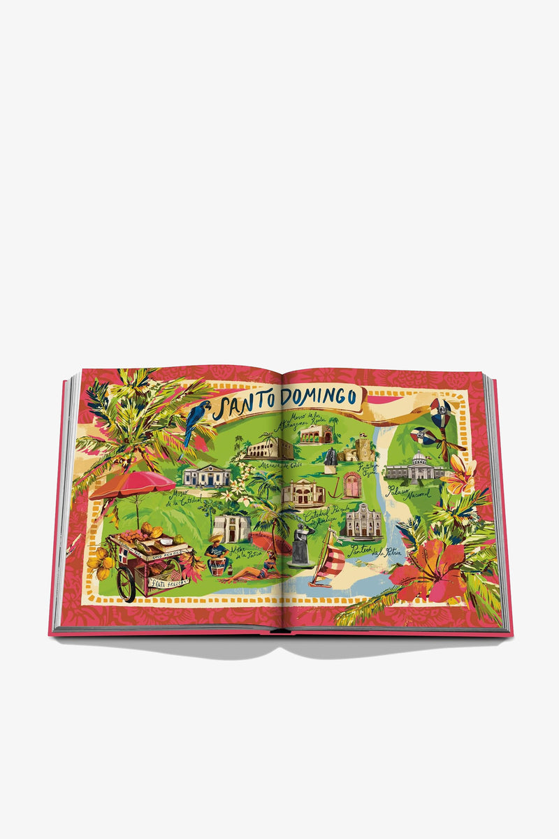 An open Assouline Santo Domingo Book displays a colorful illustrated map of Santo Domingo, showcasing landmarks, palm trees, flowers, and local scenes set against a vibrant background.