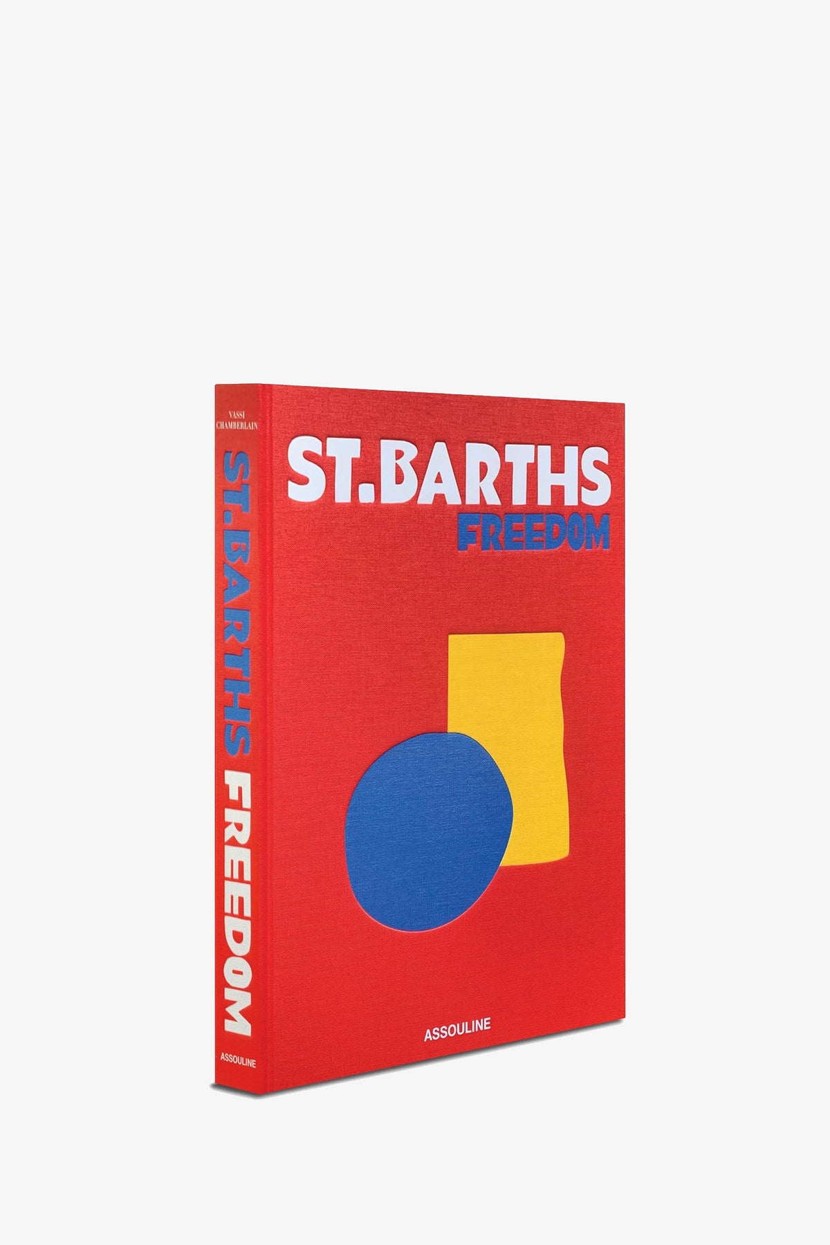 A red Assouline St Barths Freedom Book with bold white and blue text on the cover, featuring a yellow rectangle and a blue oval, and the publisher ASSOULINE printed at the bottom.