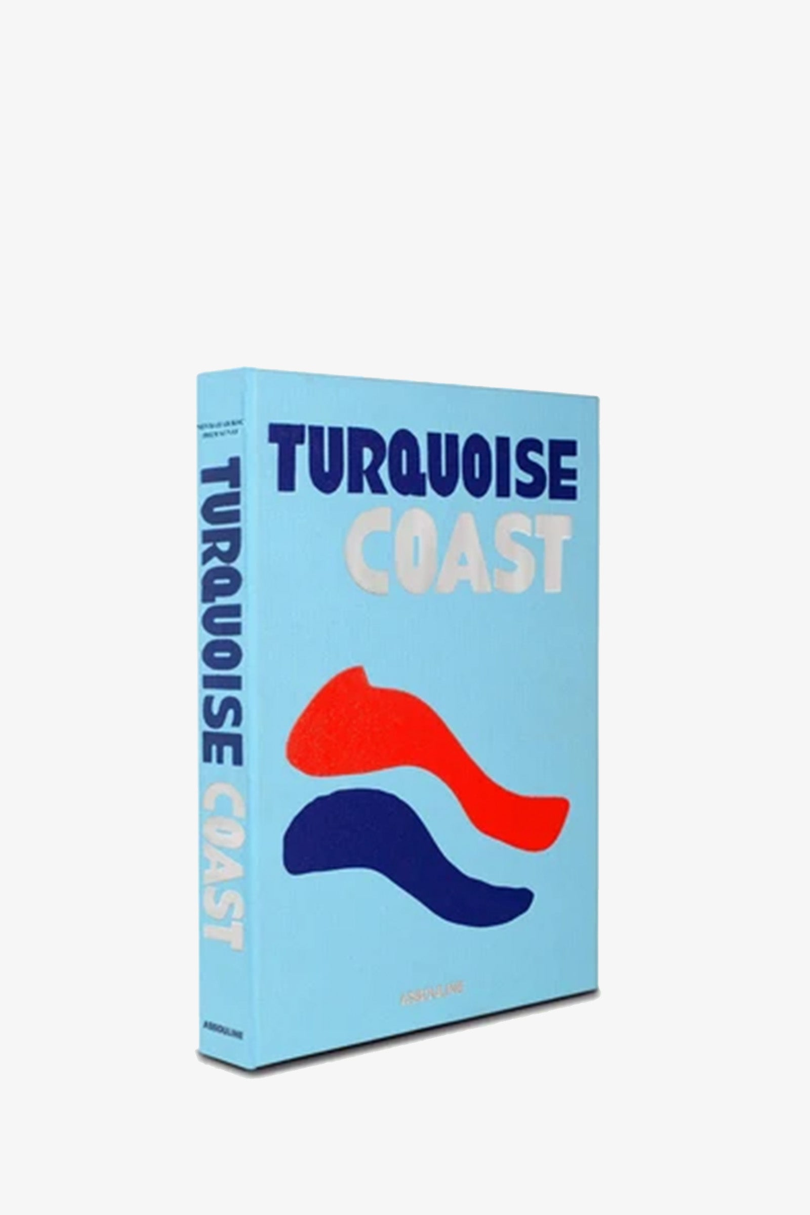 The Assouline Turquoise Coast Book features bold blue and white text atop a light blue cover adorned with abstract red and blue wave shapes, displayed standing upright against a plain white background.