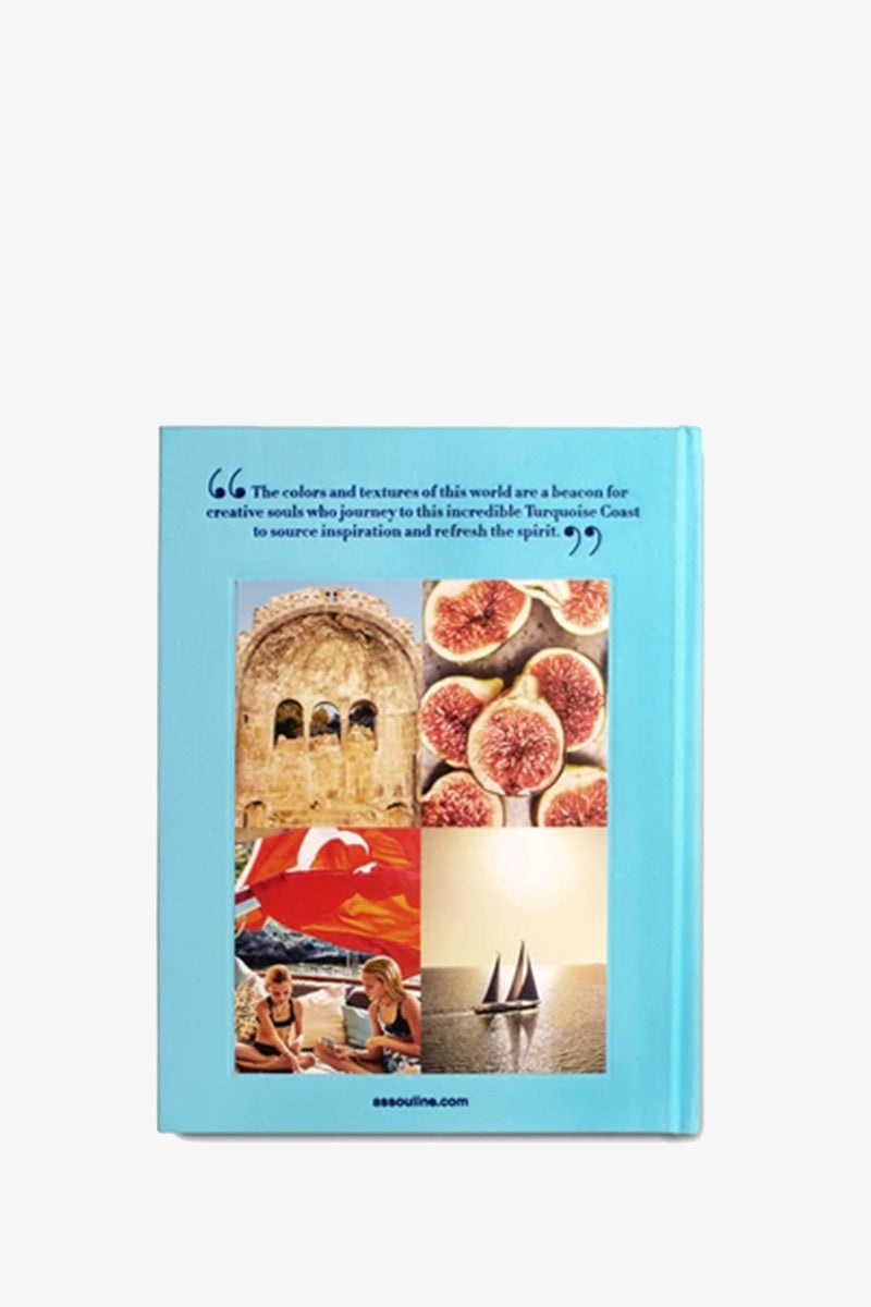 The Assouline Turquoise Coast Book features a blue cover adorned with a quote and four photographs: an ancient archway, figs, people conversing beside a pool, and a sailboat gliding on water.