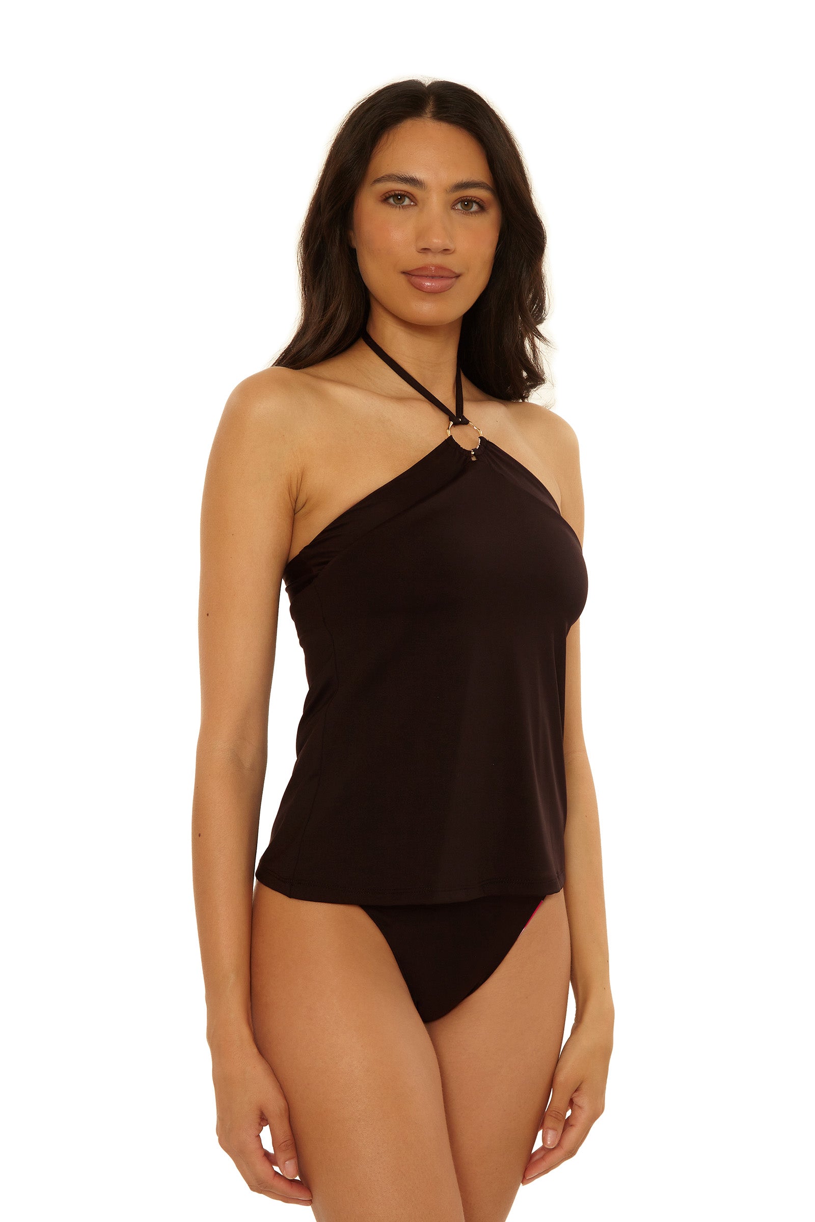 A woman with long dark hair wears the Reversible Tankini Swim Top - Bougainvillea and matching bikini bottoms, posing against a white background.
