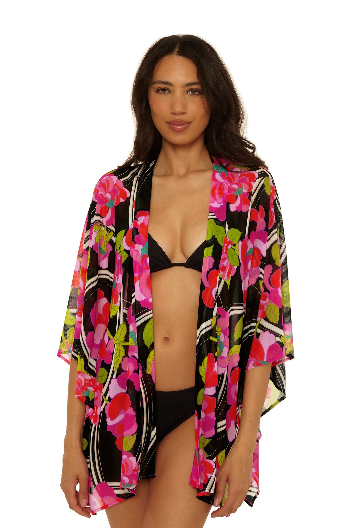 Woman models the Kimono Swim Cover-Up - Bougainvillea in Bougainvillea Swim Knit, featuring vibrant floral patterns over a black bikini, standing against a white background with a relaxed expression.