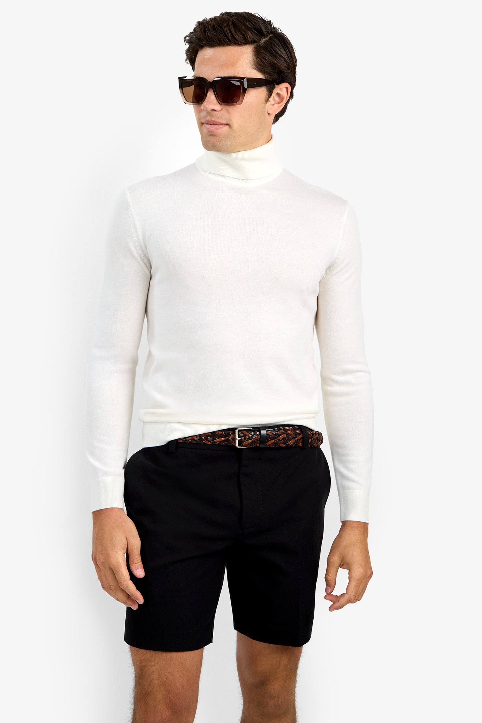 A man in dark sunglasses, black shorts, a brown patterned belt, and the Roy Long Sleeve Turtleneck stands against a plain white background.