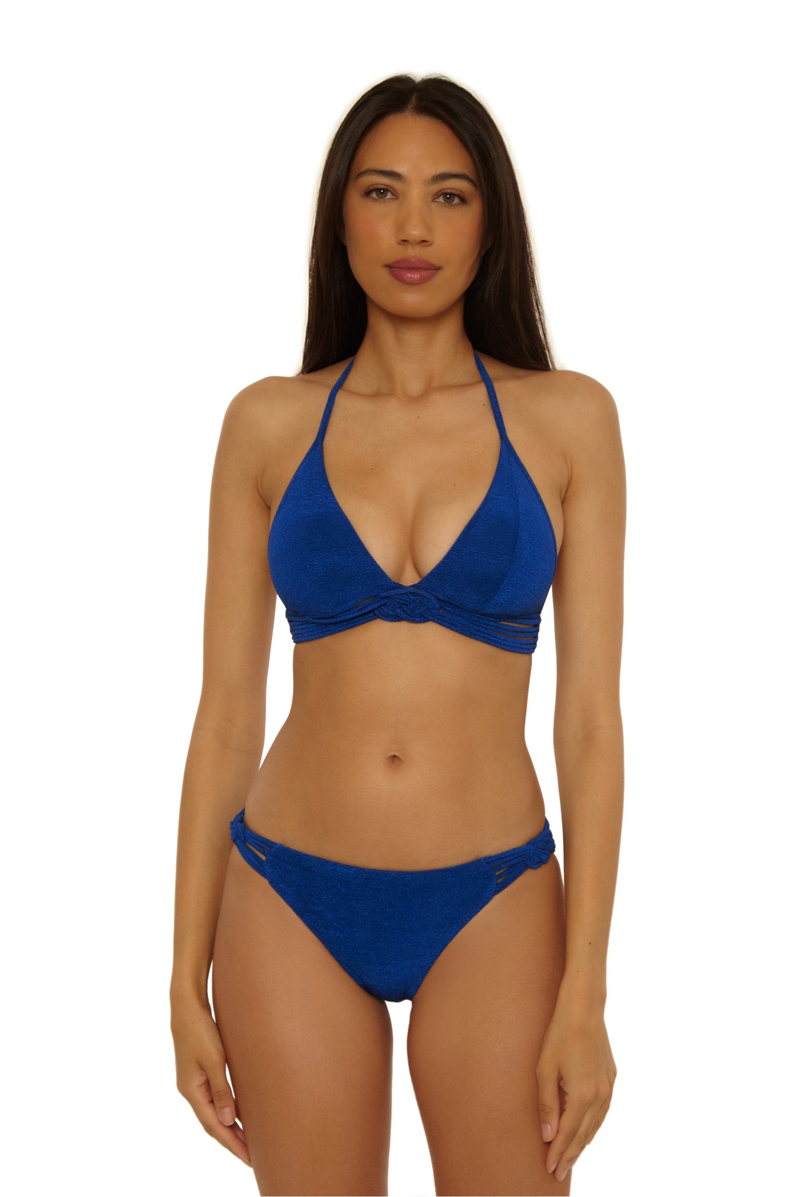 A woman with long dark hair models the Crete Crepe Braided Hipster bikini, a bright blue halter top and matching cutout side bottoms, against a white background.