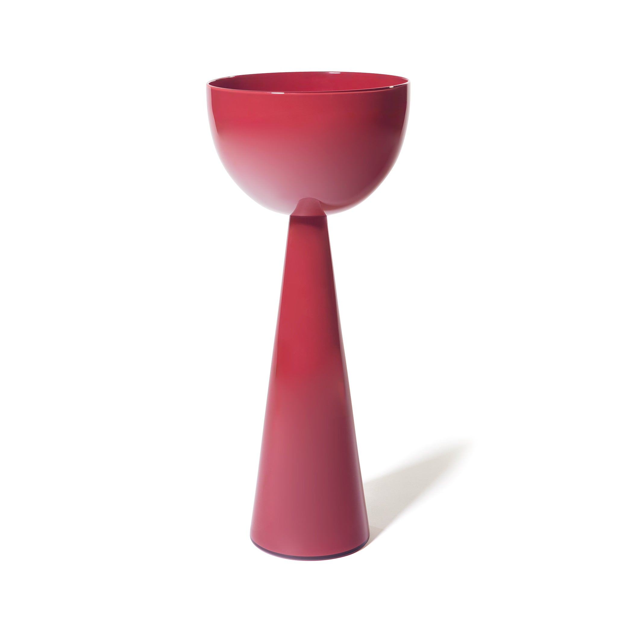 The Fiorelli Tall Bowl, featuring a modern glossy deep red finish, sits atop a matching tall conical base, creating a minimalist goblet-like silhouette against a plain white background.