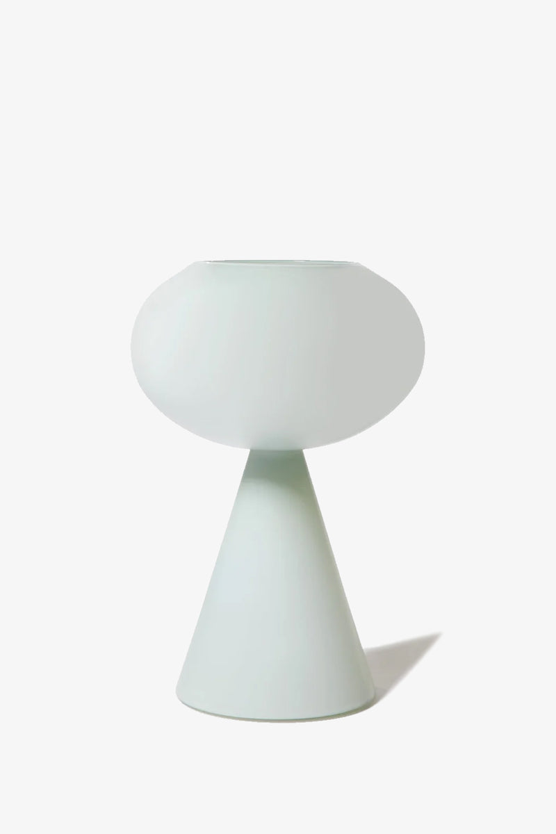 The Fiorelli Concave is a modern, minimalist vase featuring a wide, rounded top and a conical base in a smooth, pale mint color, displayed against a plain white background.