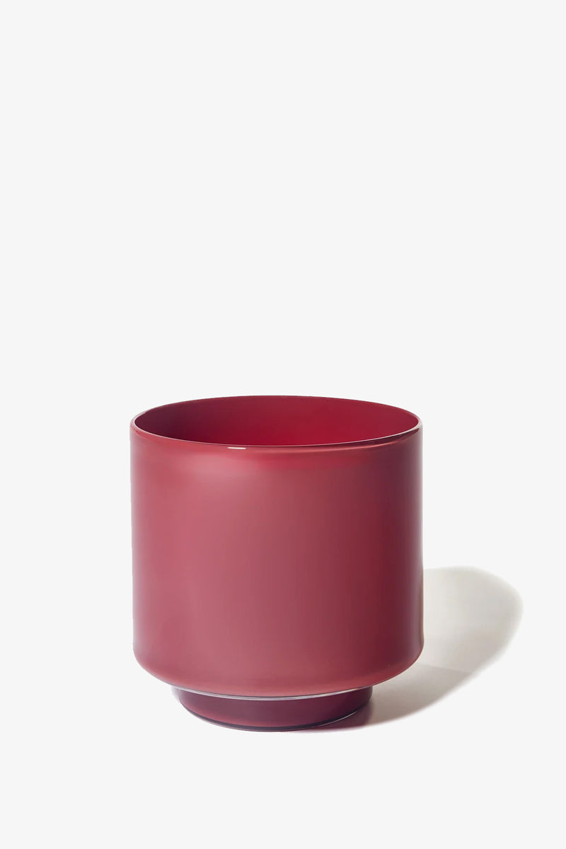 The Fiorelli Low Container is a matte red cylindrical ceramic planter with a slightly rounded base, shown on a white background with a faint shadow to the right.