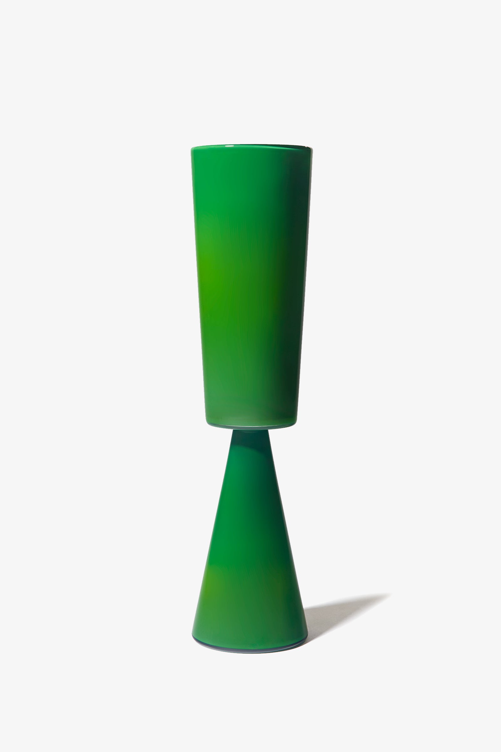 The Fiorelli Tall Cylinder is a green ceramic vase featuring a tall cylindrical top and a cone-shaped base, shown standing upright against a plain white background.