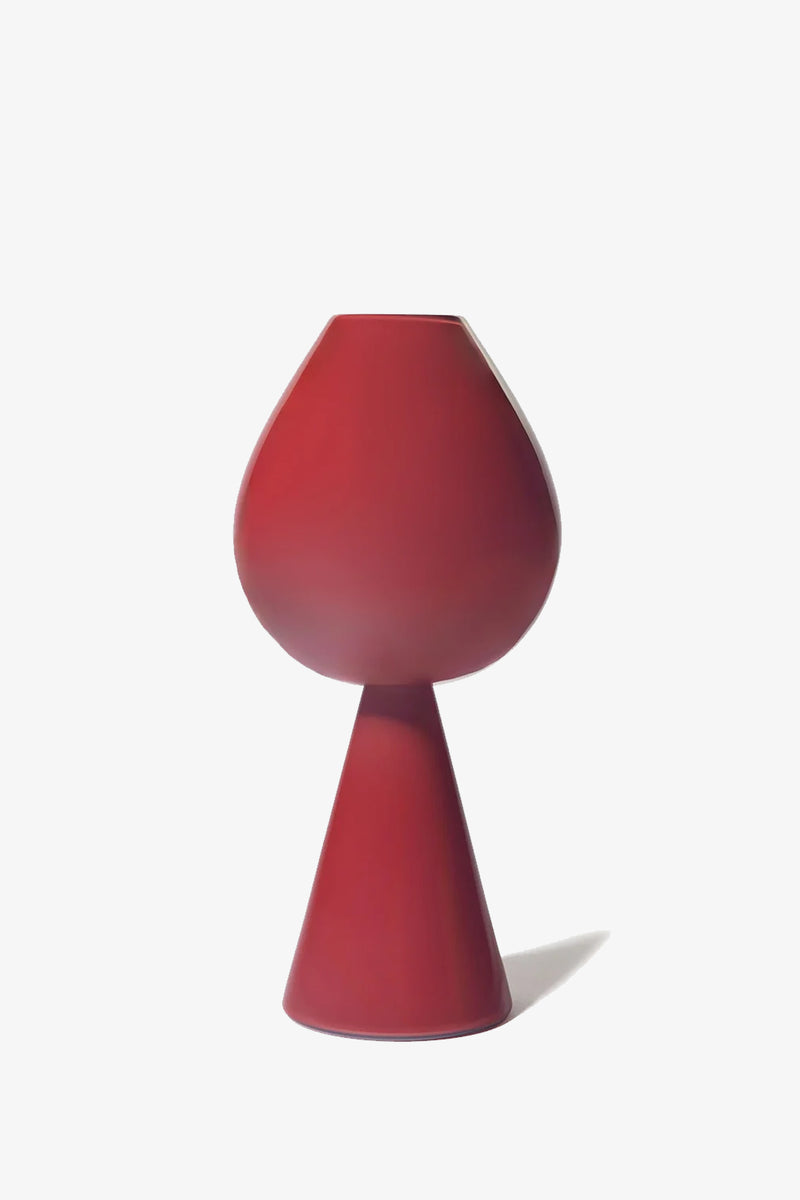 Fiorelli Tulip: A modern red vase featuring a wide, rounded top and a narrow, cone-shaped base, showcased against a plain white background.