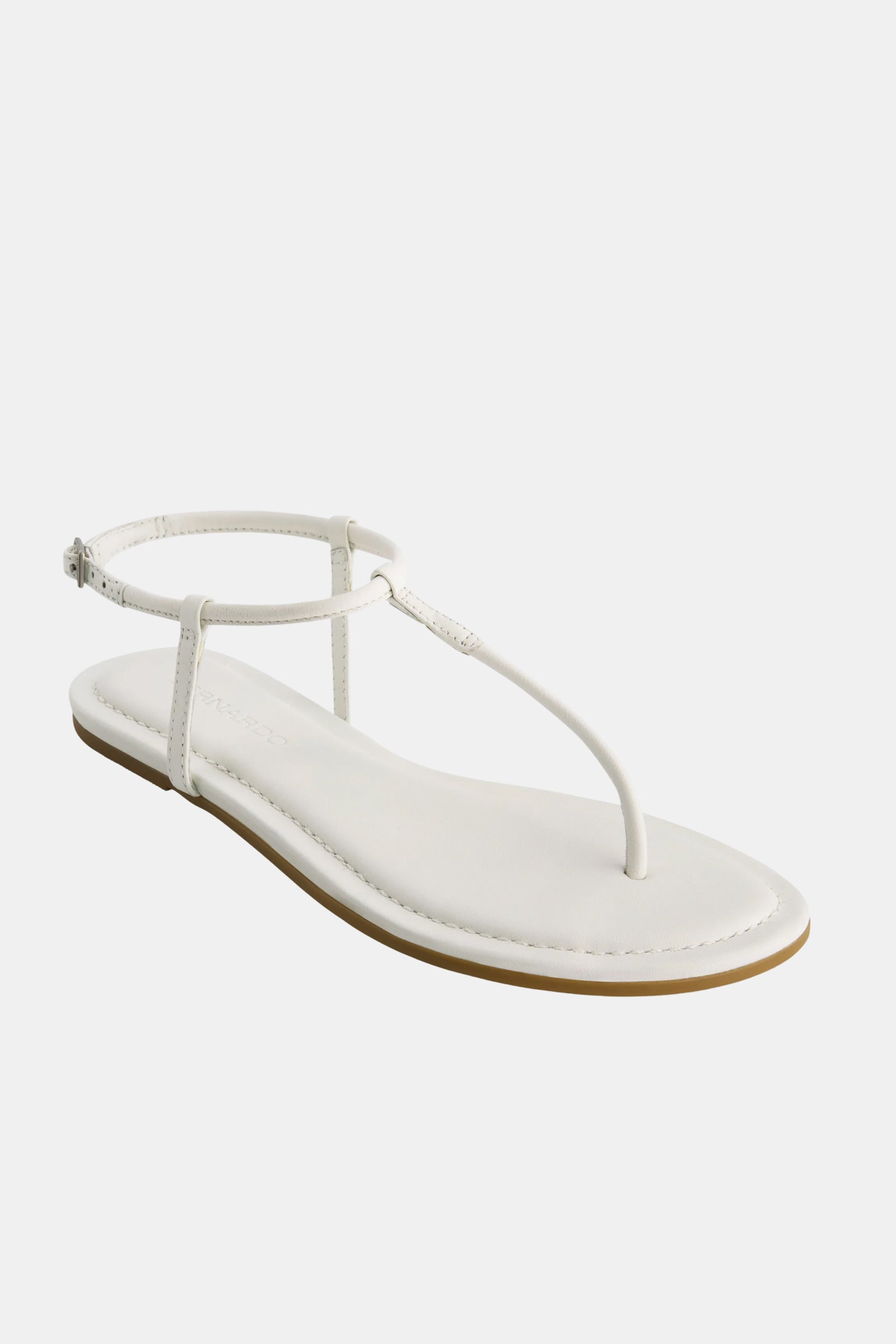 The Hercu Sandal is a minimalist white sandal featuring a thin sole, thong-style toe strap, and adjustable ankle strap, showcased against a plain white background.