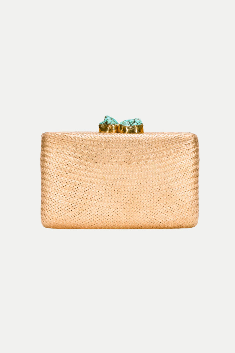 The Jen Gold Straw Clutch features a rectangular gold woven design with a textured surface and a decorative closure adorned with two turquoise stones, shown against a plain white background.