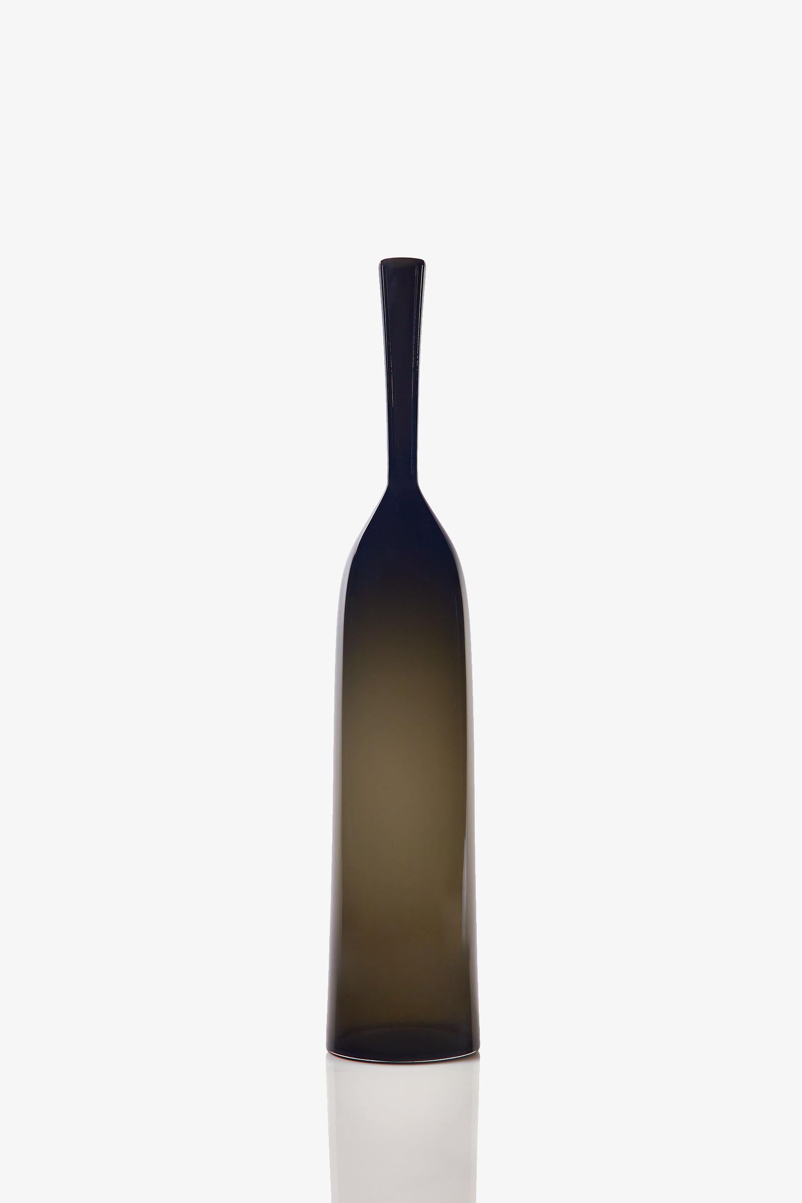 A Large Angelic Bottle, featuring a tall, dark translucent glass body with a narrow neck and a smooth, minimalist design, stands upright against a plain white background.