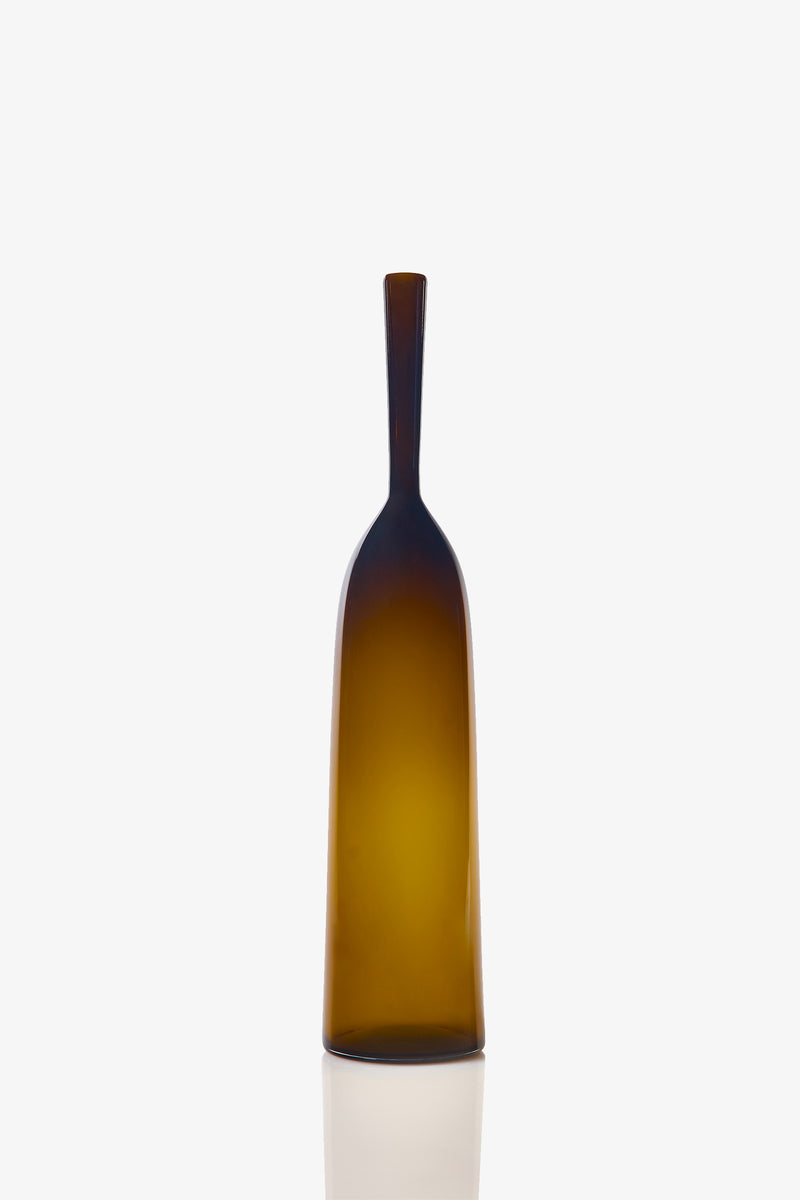 A Large Angelic Bottle, featuring a tall, narrow design with an amber-colored glass body, long neck, and flat base, is set against a plain white background.