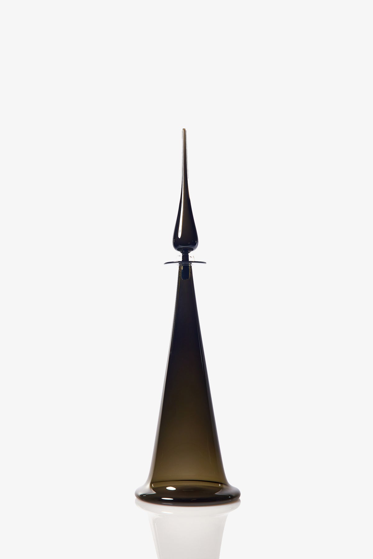 A Large Fluted Cone Decanter made of dark glass, featuring a wide base that tapers elegantly to a narrow, pointed top, is displayed against a plain white background.