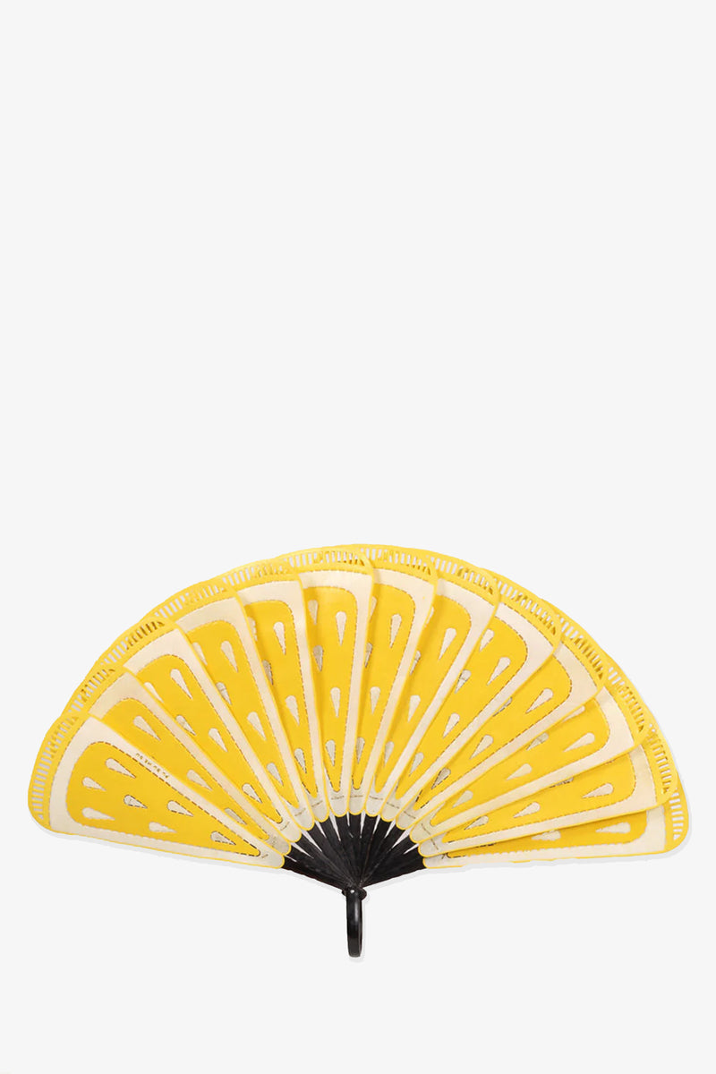 The Pu Bu Me Su Lemon Fan is a handheld fan with yellow and white segments resembling lemon slices and a black handle, shown against a white background.